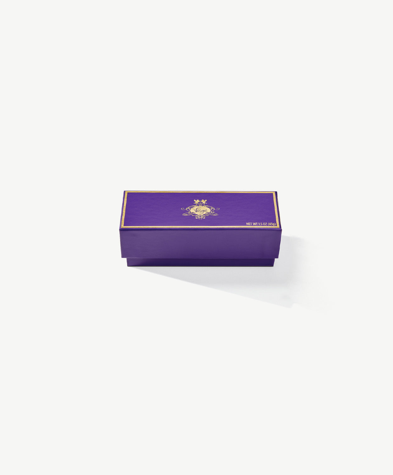 A small, rectangular purple chocolate candy box embossed with gold foil Vosges Haut-Chocolat logo sits closed on a grey background.