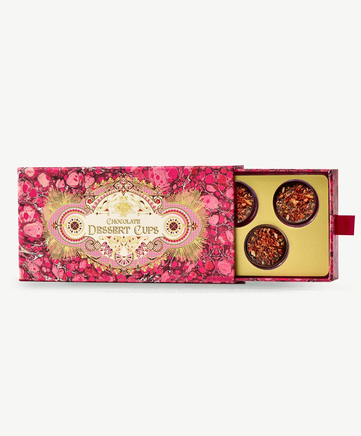 An extravagant pink and gold box is slid open to reveal champagne dessert cups adorned with dried dragon fruit