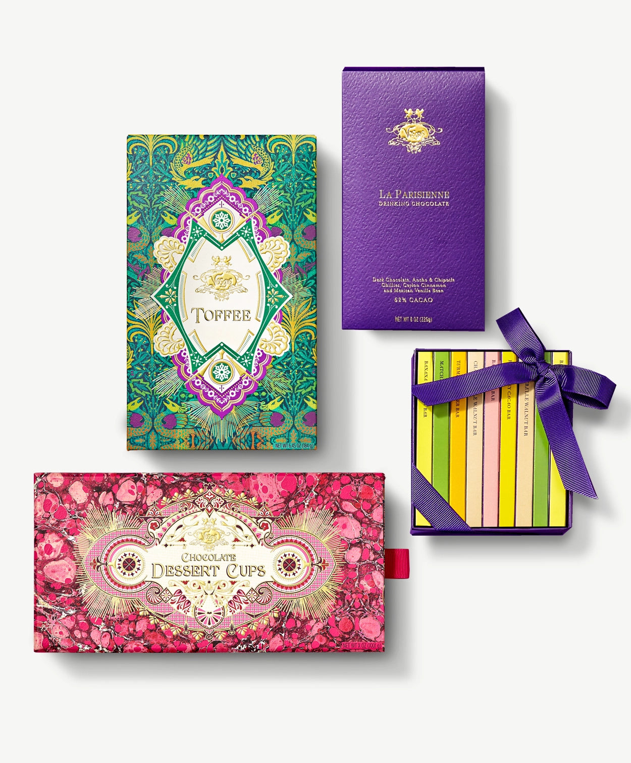 Four Vosges collections: Gingerbread Toffee, Champagne Dessert Cups, Mini Chocolate Bar Library and La Parisienne drinking chocolate sit on a light grey background.