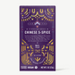 Vosges Chinese 5 spice Pure Plant chocolate bar stands upright in a dark purple box  decorated with golden suns and moons on a grey background. 