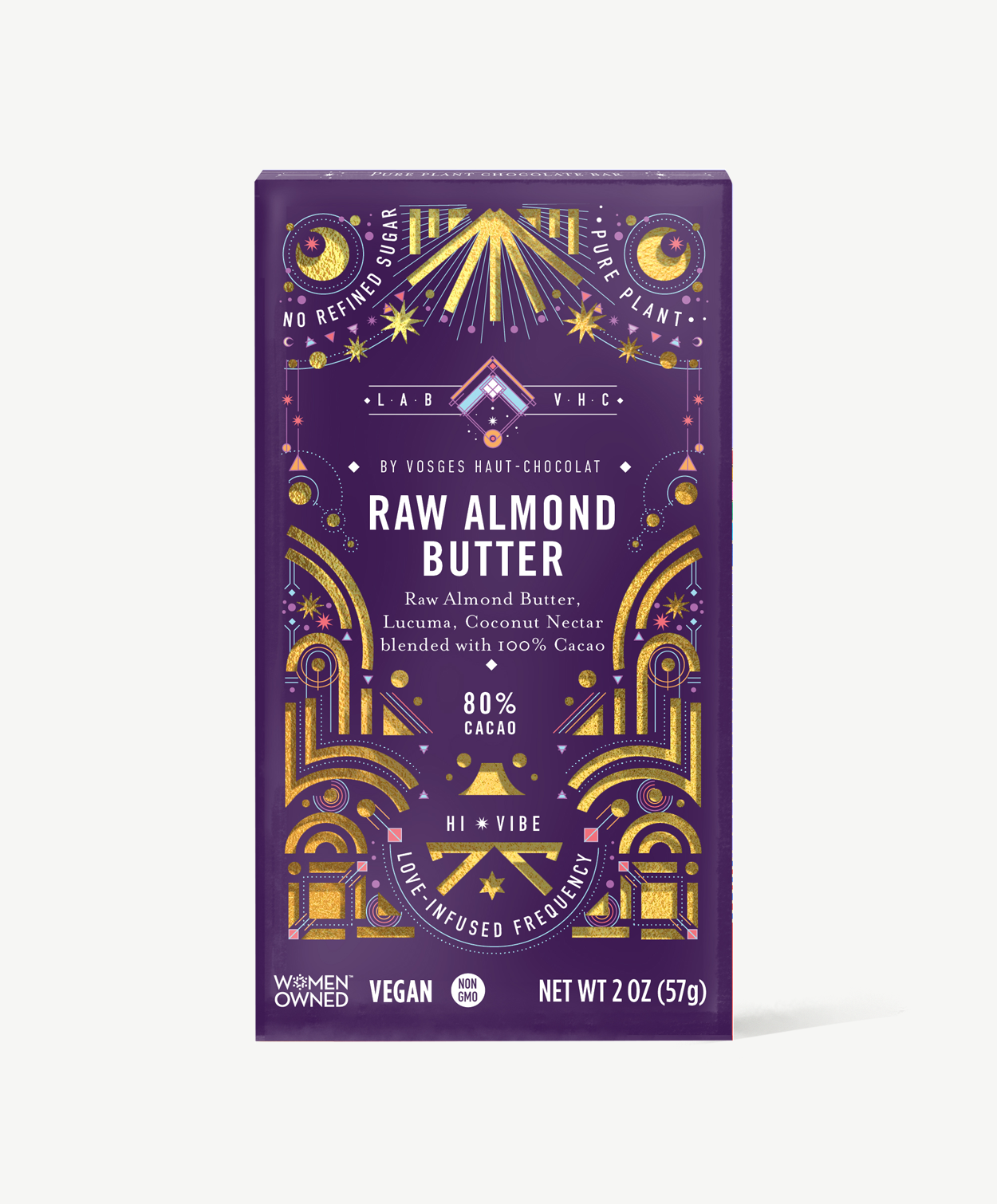 Vosges Raw Almond Butter Pure Plant chocolate bar stands upright in a dark purple box decorated with golden suns and moons on a grey background.
