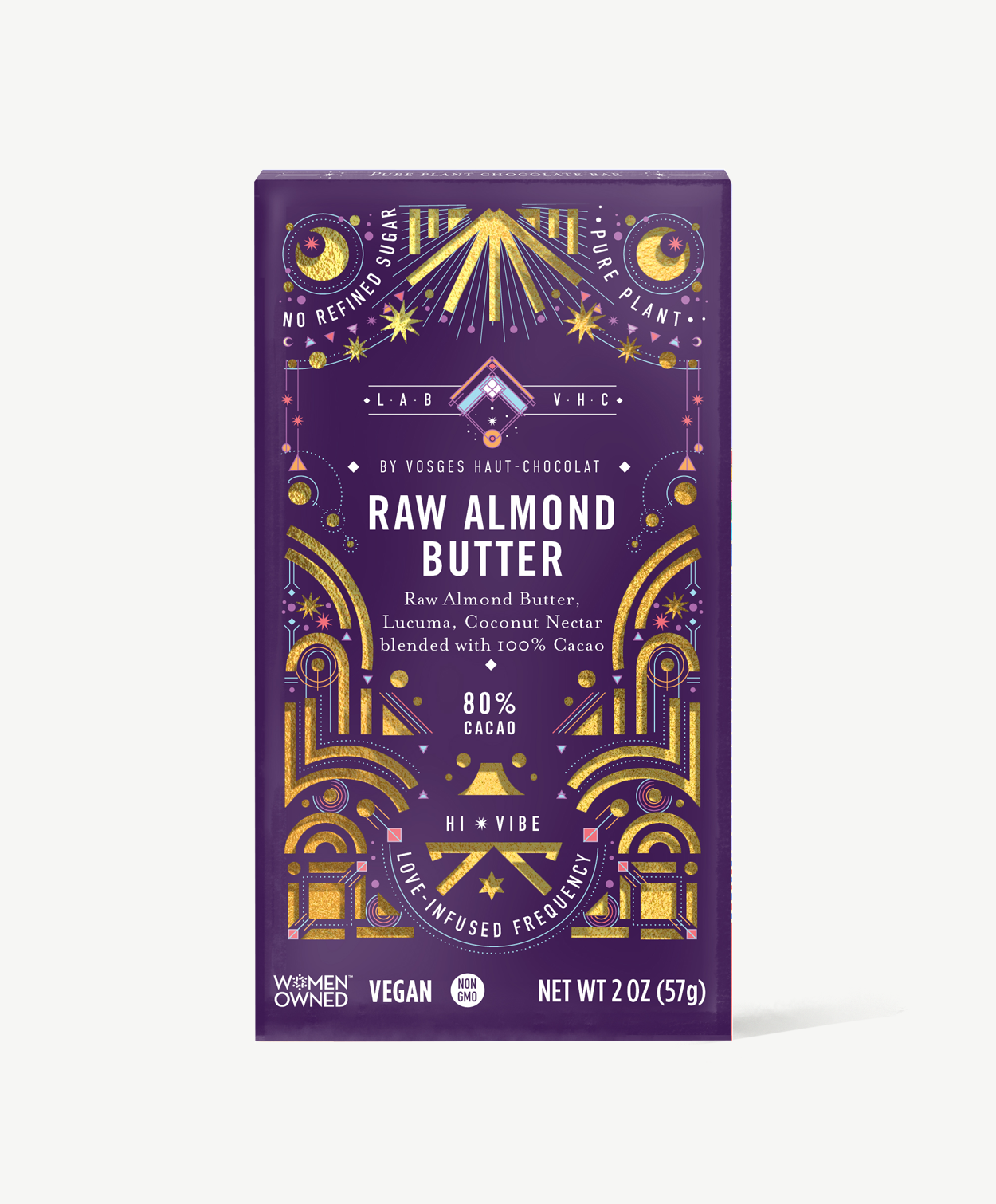 Vosges Raw Almond Butter Pure Plant chocolate bar stands upright in a dark purple box  decorated with golden suns and moons on a grey background.