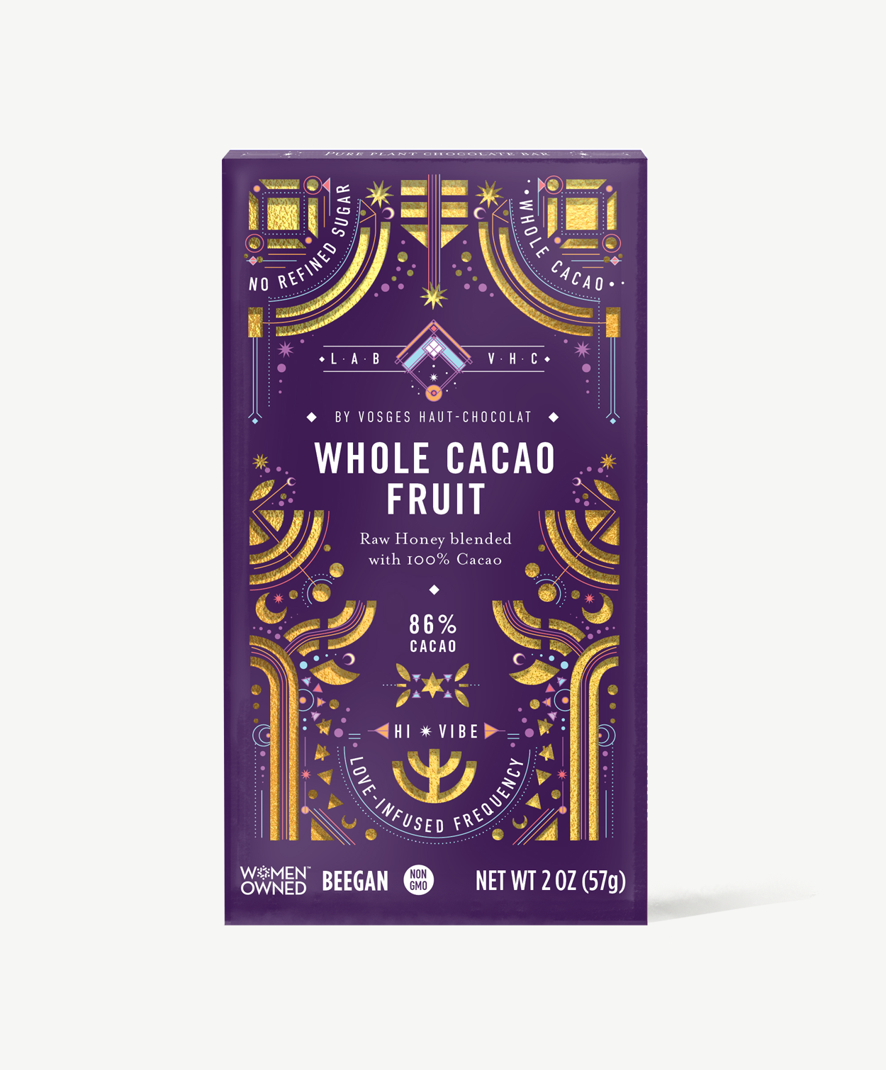 Vosges whole cacao fruit chocolate bar stands upright in a dark purple box decorated with golden suns and moons on a grey background.