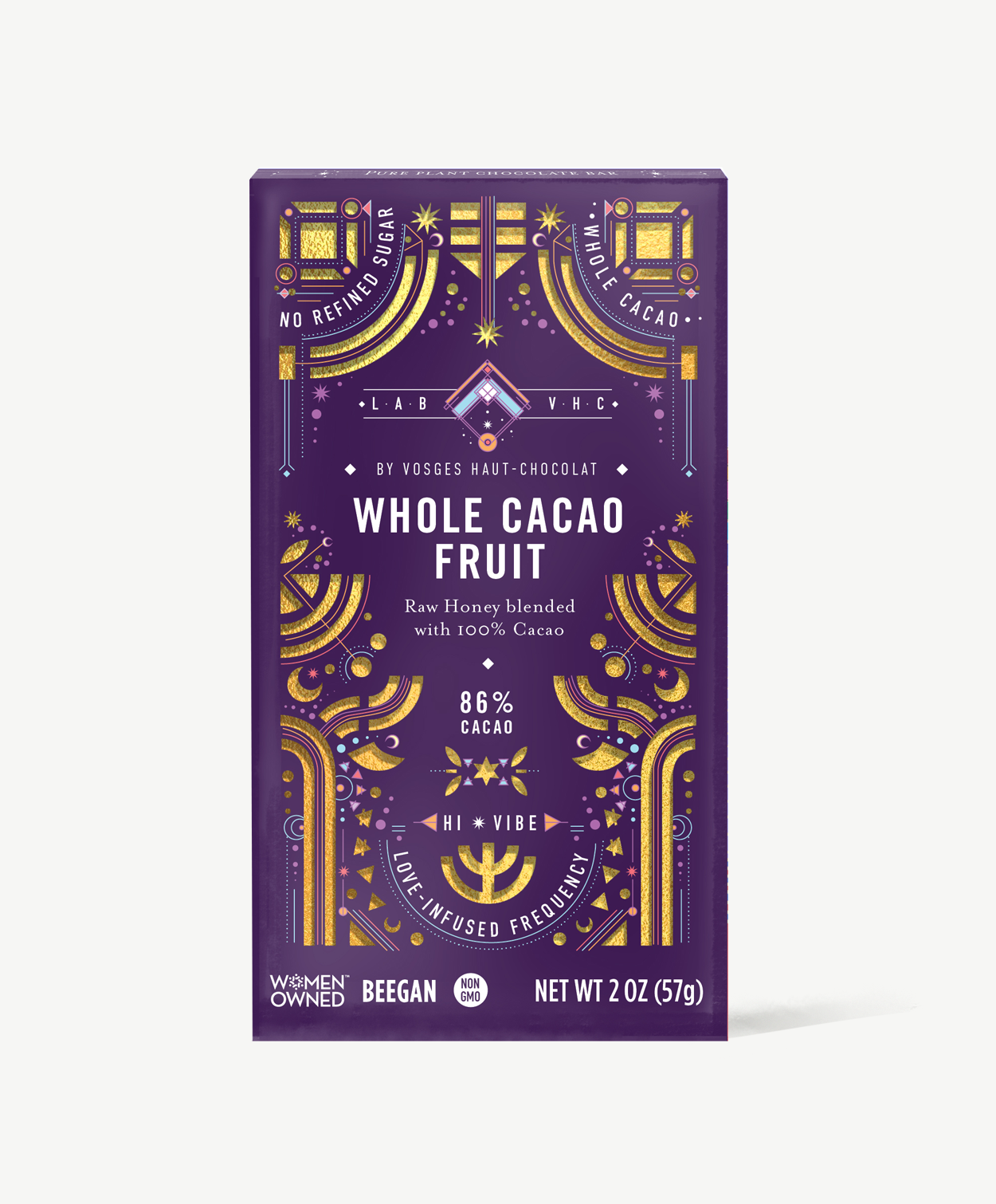 Vosges whole cacao fruit chocolate bar stands upright in a dark purple box  decorated with golden suns and moons on a grey background.