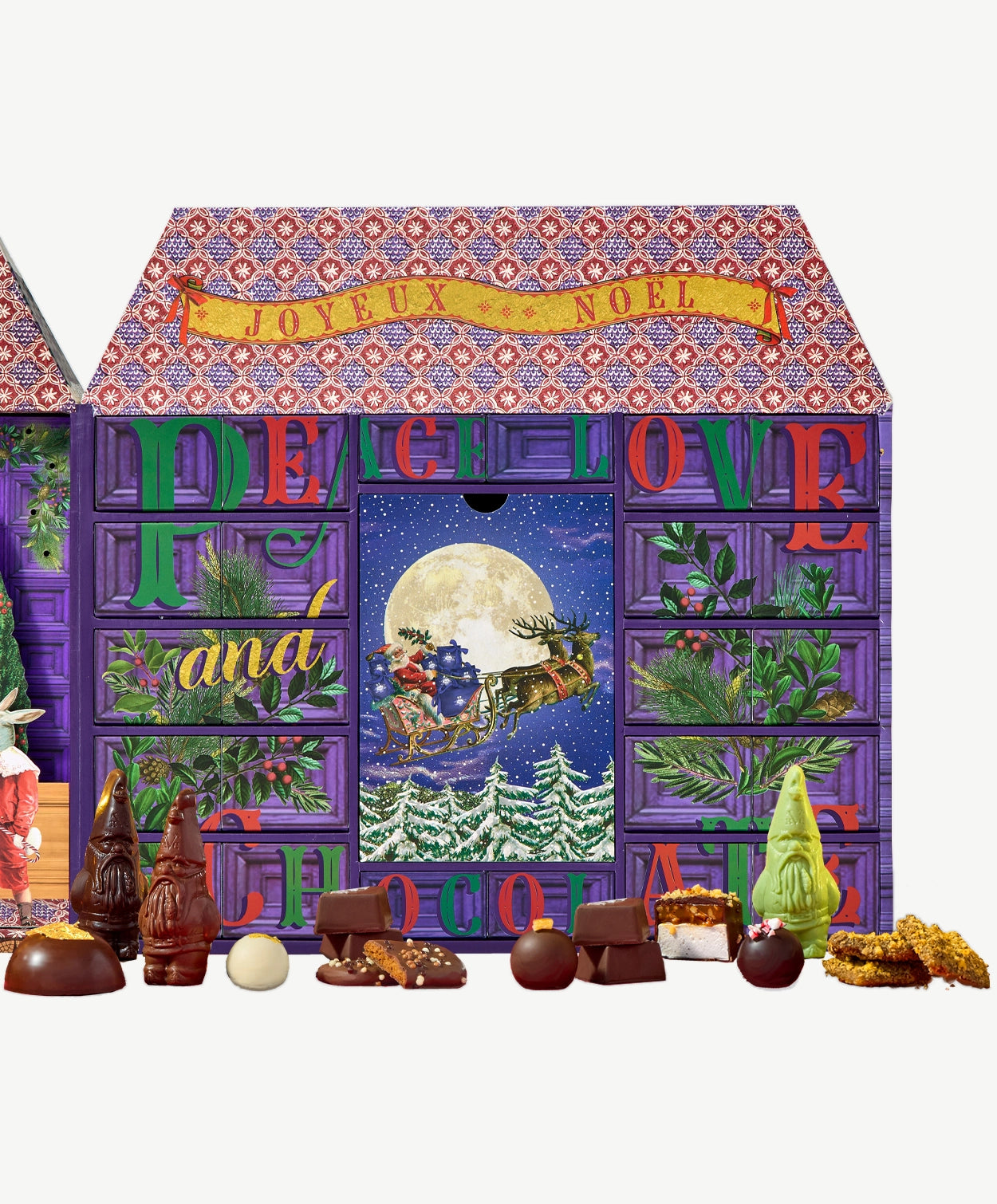 A Vosges Advent calendar sits open displaying several drawers of holiday confections surrounding an image of Santa and his sleigh flying infront a large full moon..