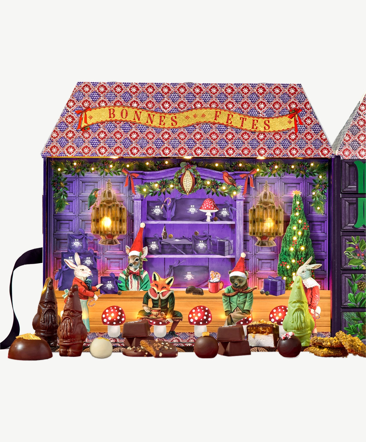 A group of woodland friends including a bear, fox, faun and two bunnies gather at the Vosges counter to enjoy holiday chocolate confections.  The cozy purple room is brightly lit with festive holiday lights, garland, holly and a regal evergreen tree.