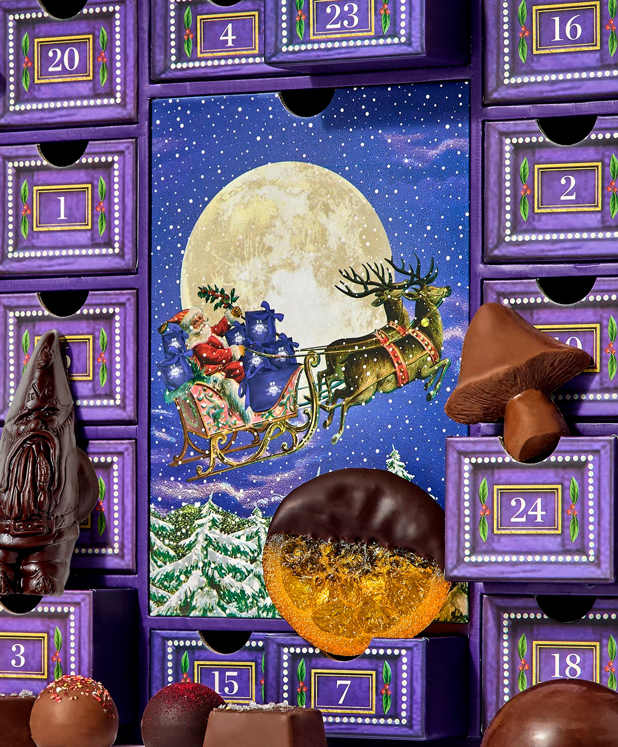 Santa and his Sleigh drawn by two reindeer fly in front of a full moon as the centerpiece drawer in the Vosges Calendar of Advent.