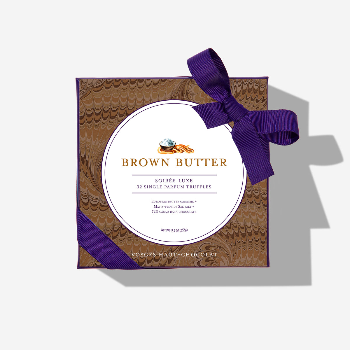 Brown Butter Truffles gift box wrapped in brown patterned paper with a purple ribbon