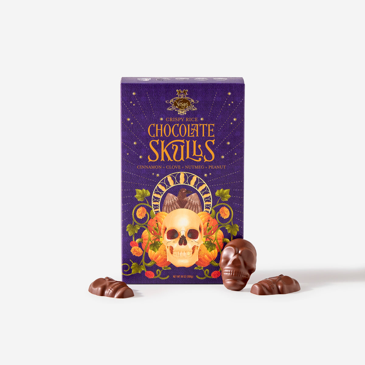 A box of Chocolate Skulls with three chocolate skull candies placed in front on a clean white background.