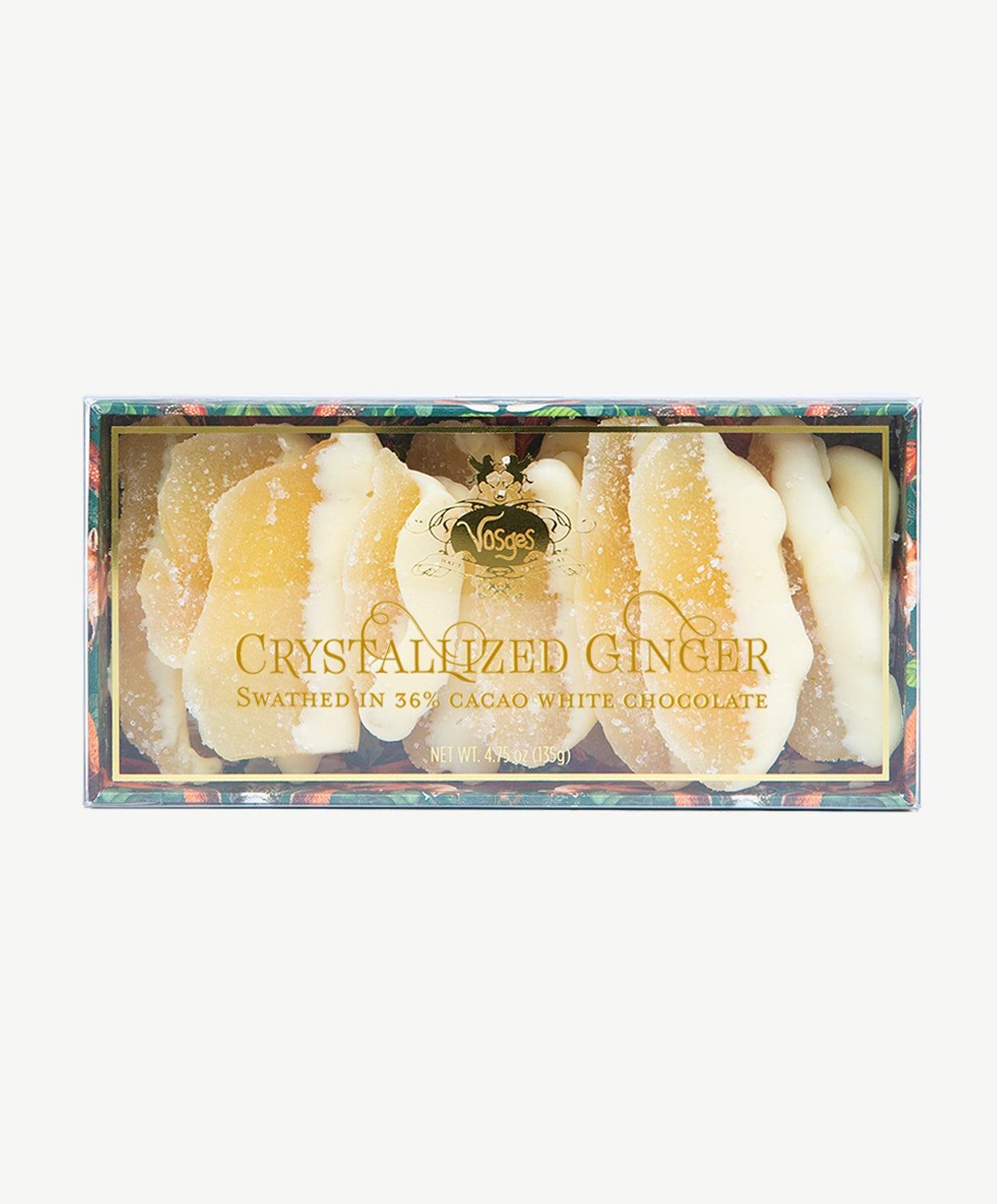 A close up view of Vosges white chocolate dipped Crystalized Ginger in a transparent box adorned with gold text on a light grey background.