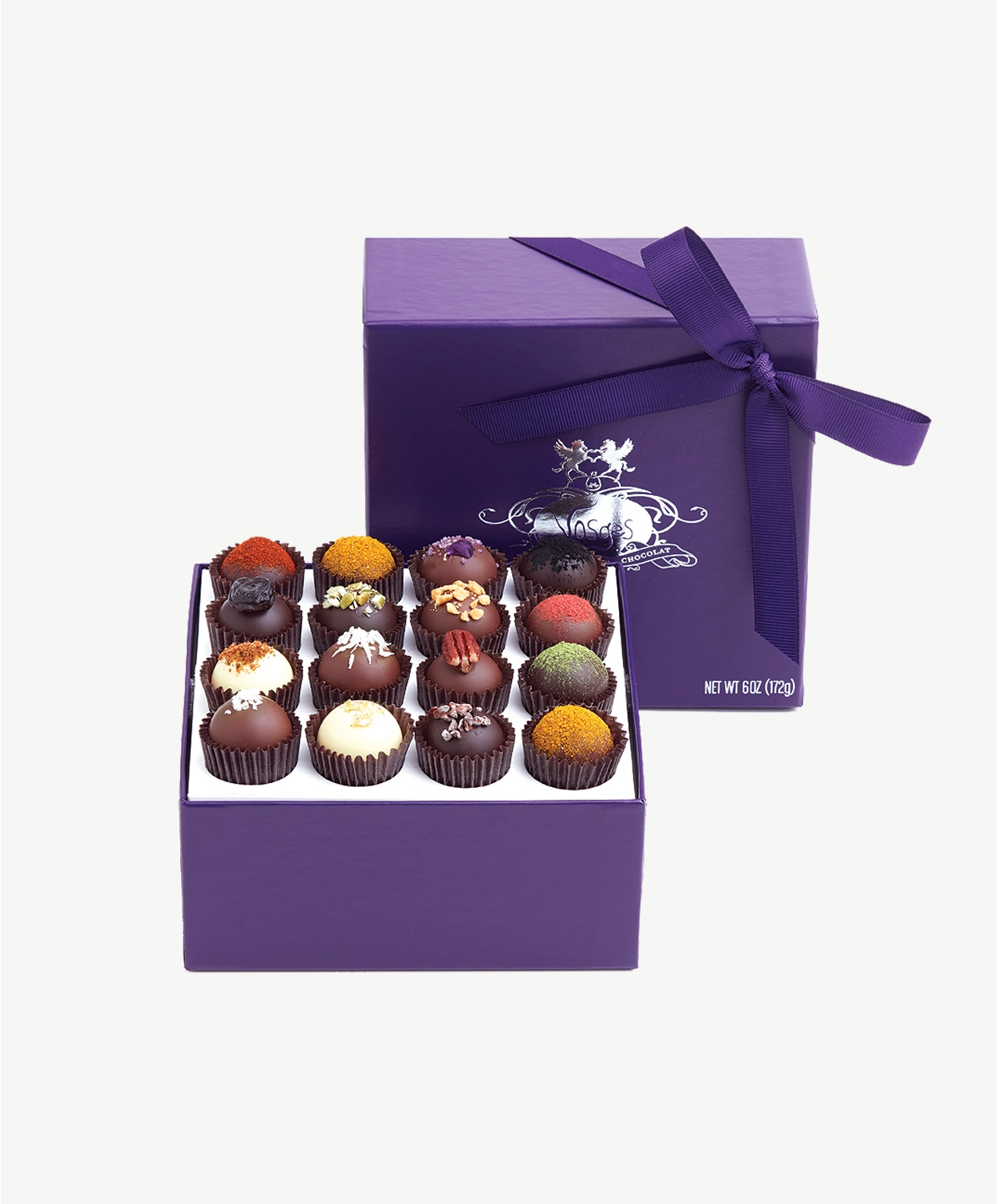 Open box of Vosges Haut-Chocolat Exotic Chocolate Truffles dusted with colorful toppings.