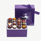 Open box of Vosges Haut-Chocolat Exotic Chocolate Truffles dusted with colorful toppings.