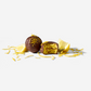 Chocolate truffles with a yellow filling on a white background