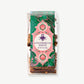Vosges Gingerbread Speculoos coated toffee in a clear plastic bag bearing a pink and green label stands upright on a white background.