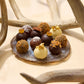 Close up of natural driftwood with several chocolate truffles at the bottom