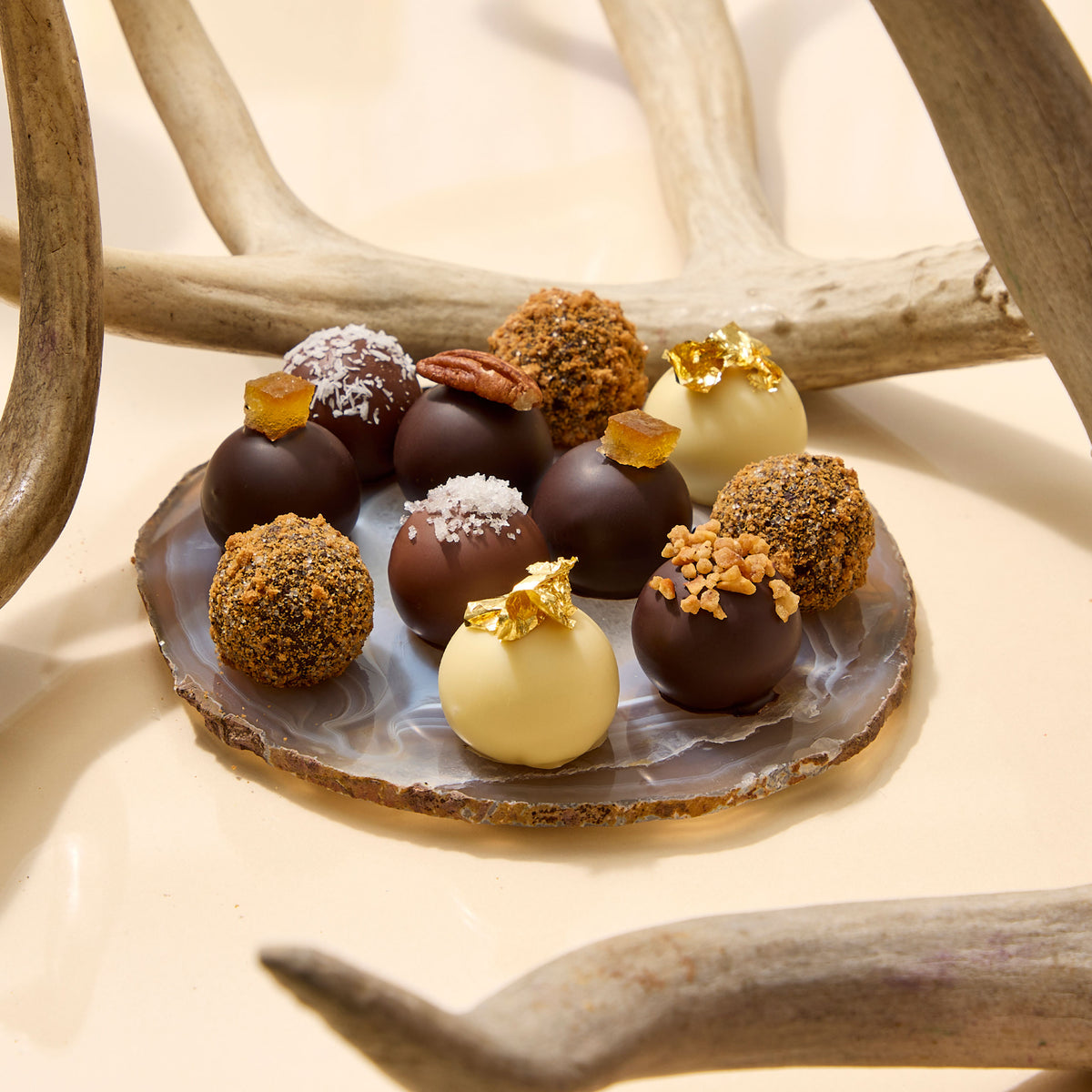 Close up of natural driftwood with several chocolate truffles at the bottom