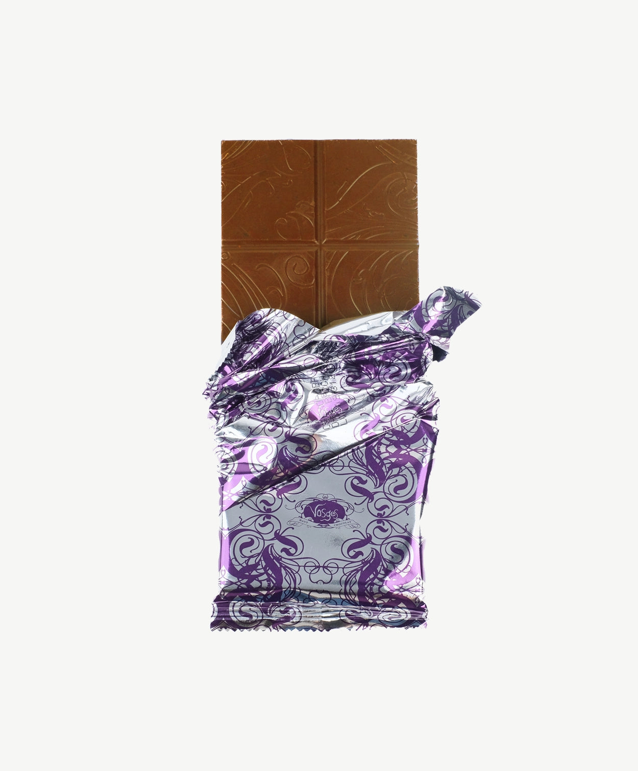 Vosges Turmeric Ginger Chocolate bar unwrapped stands upright on a white background.