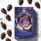 A purple and blue box reading, "Trick or Treat" along with several chocolate skulls sits on a marble background.
