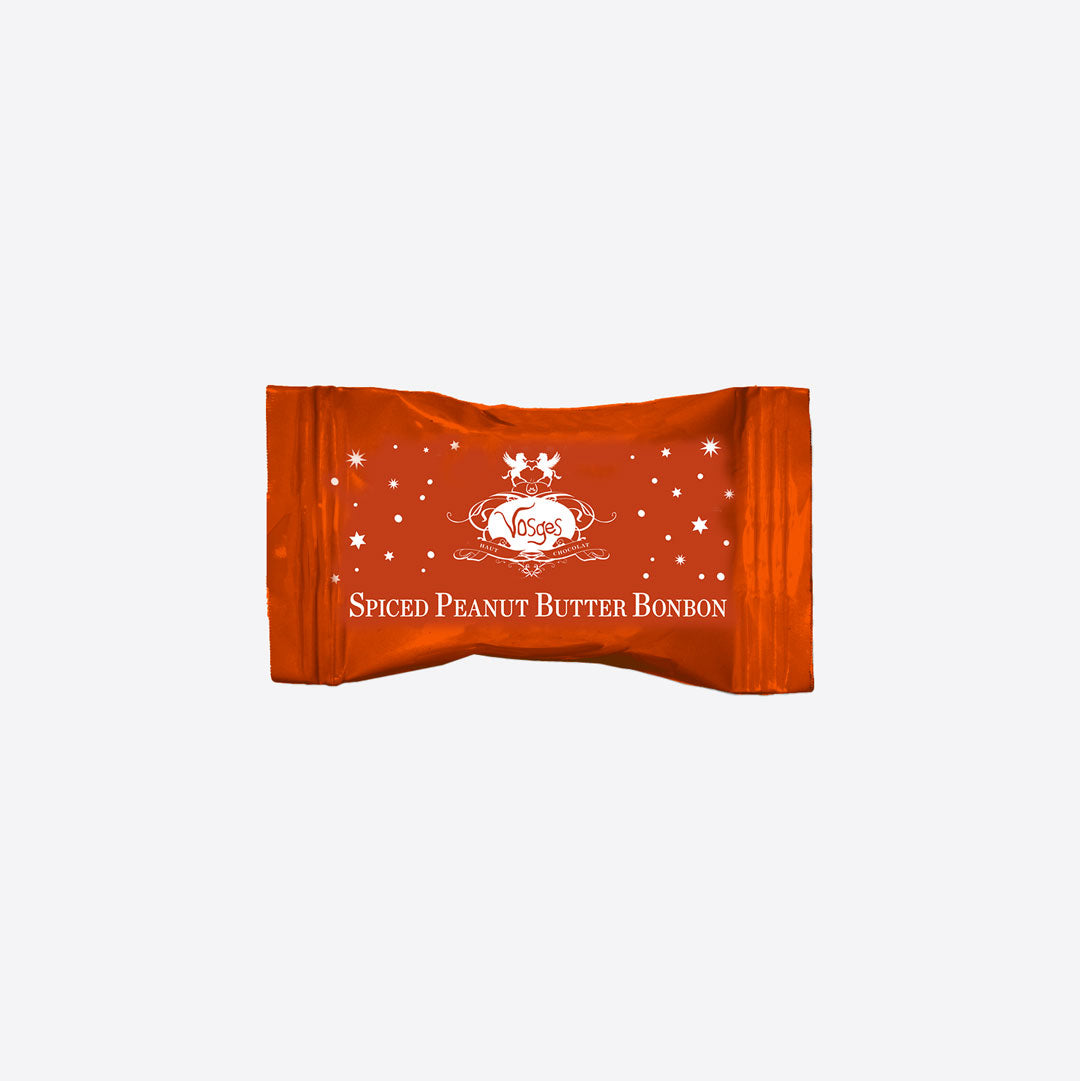 Spiced Peanut Butter Bonbon wrapper in orange with white crest and star motifs.