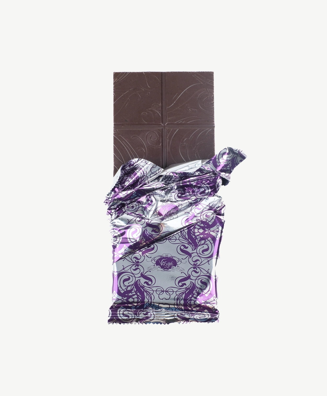 An opened Vosges Pink Salt Caramel Chocolate bar in a silver wrapper stands upright on a white background.