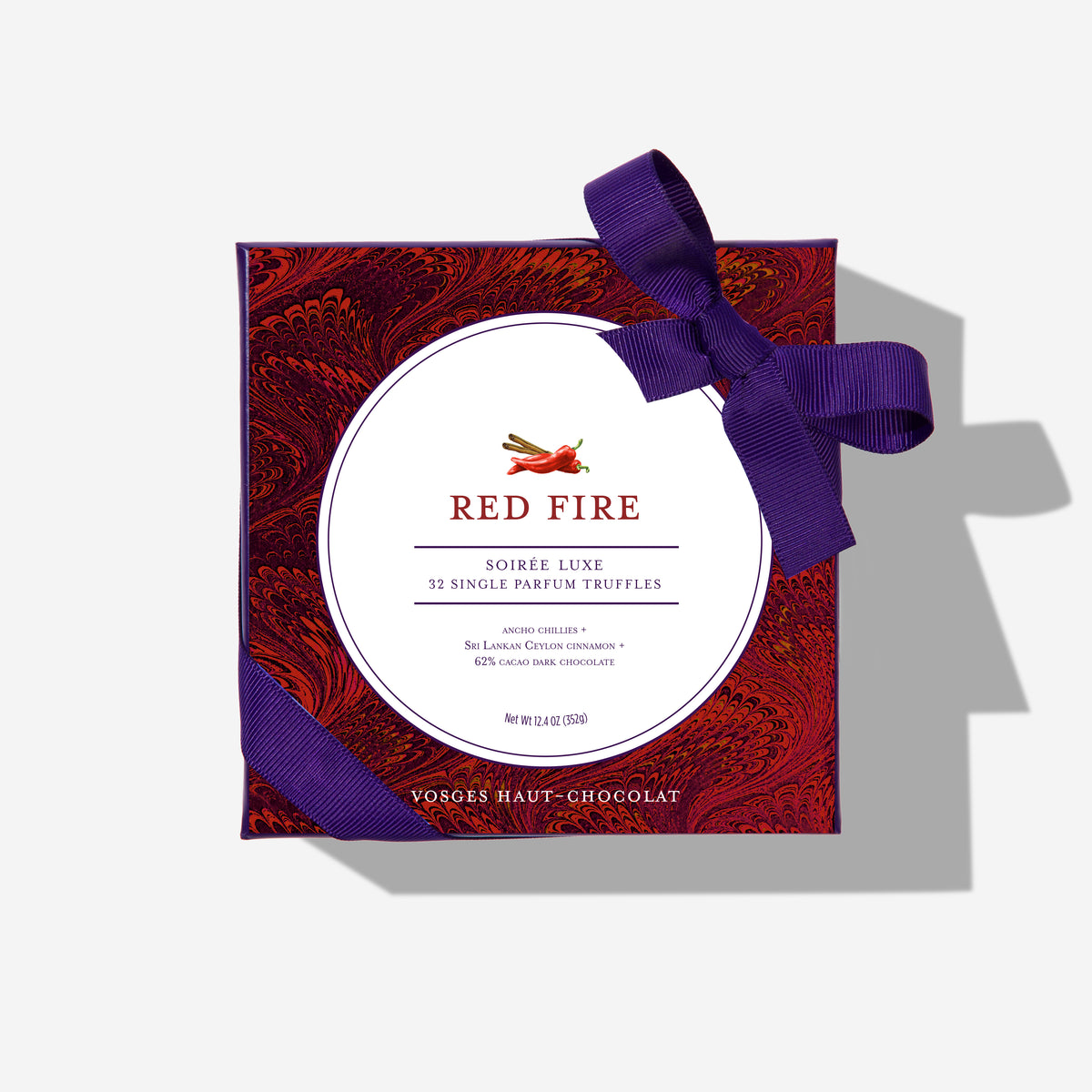 Red Fire Truffles gift box with a purple ribbon and ornate burgundy wrapping