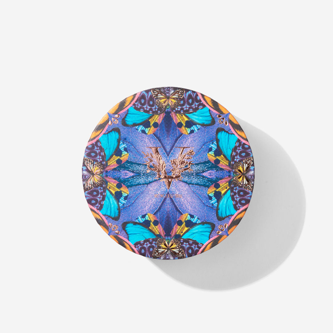 Colorful butterfly-patterned compact mirror on a white background