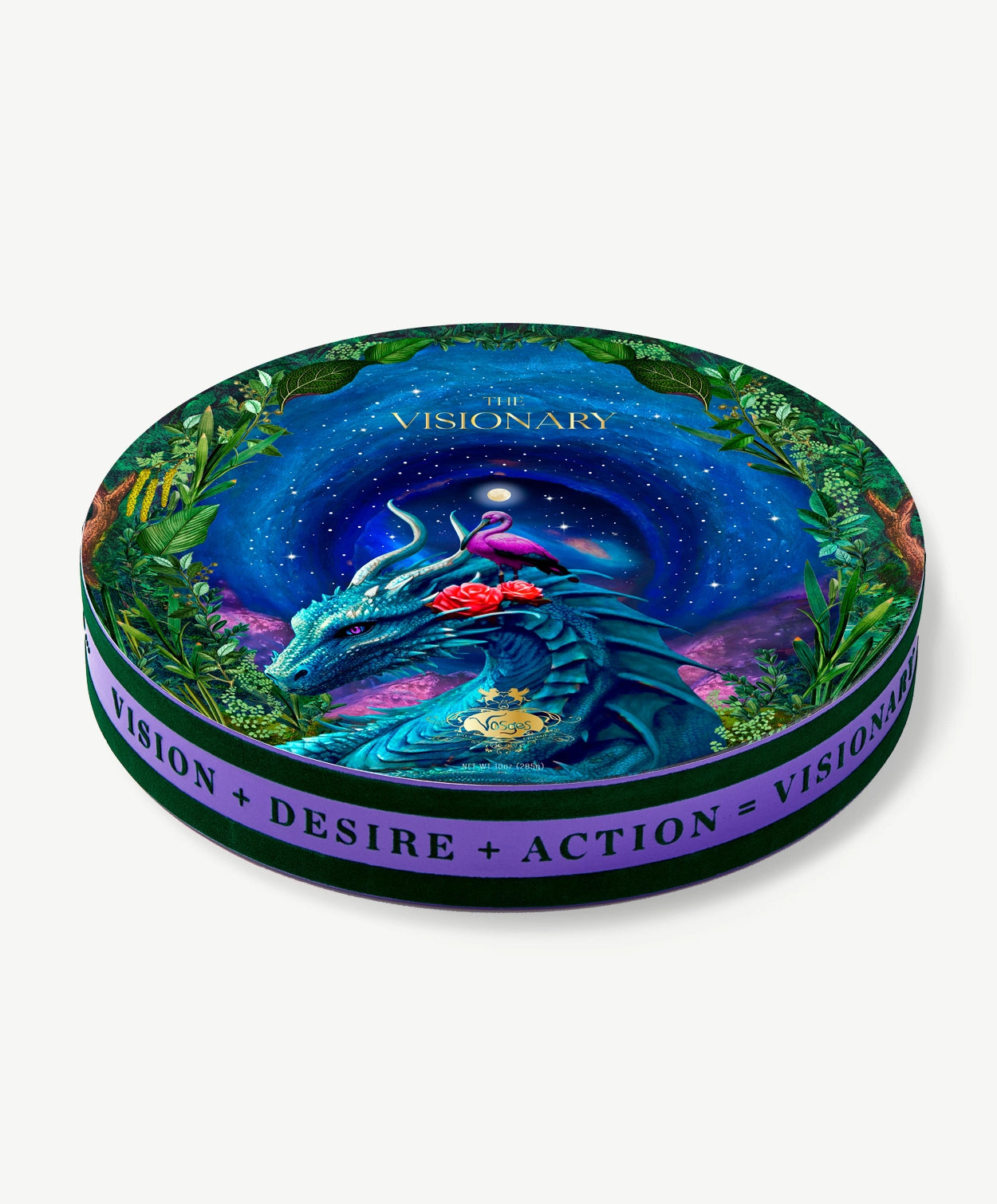 A circular Vosges chocolate collection box trimmed in purple velvet, decorated with a blue dragon and pink egret in a green forest in front a dark nighttime sky, on a light grey background. 