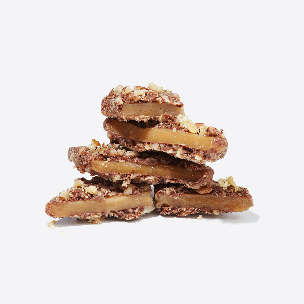 Stack of almond studded caramel chocolates from Best of Vosges Hatbox on a white background