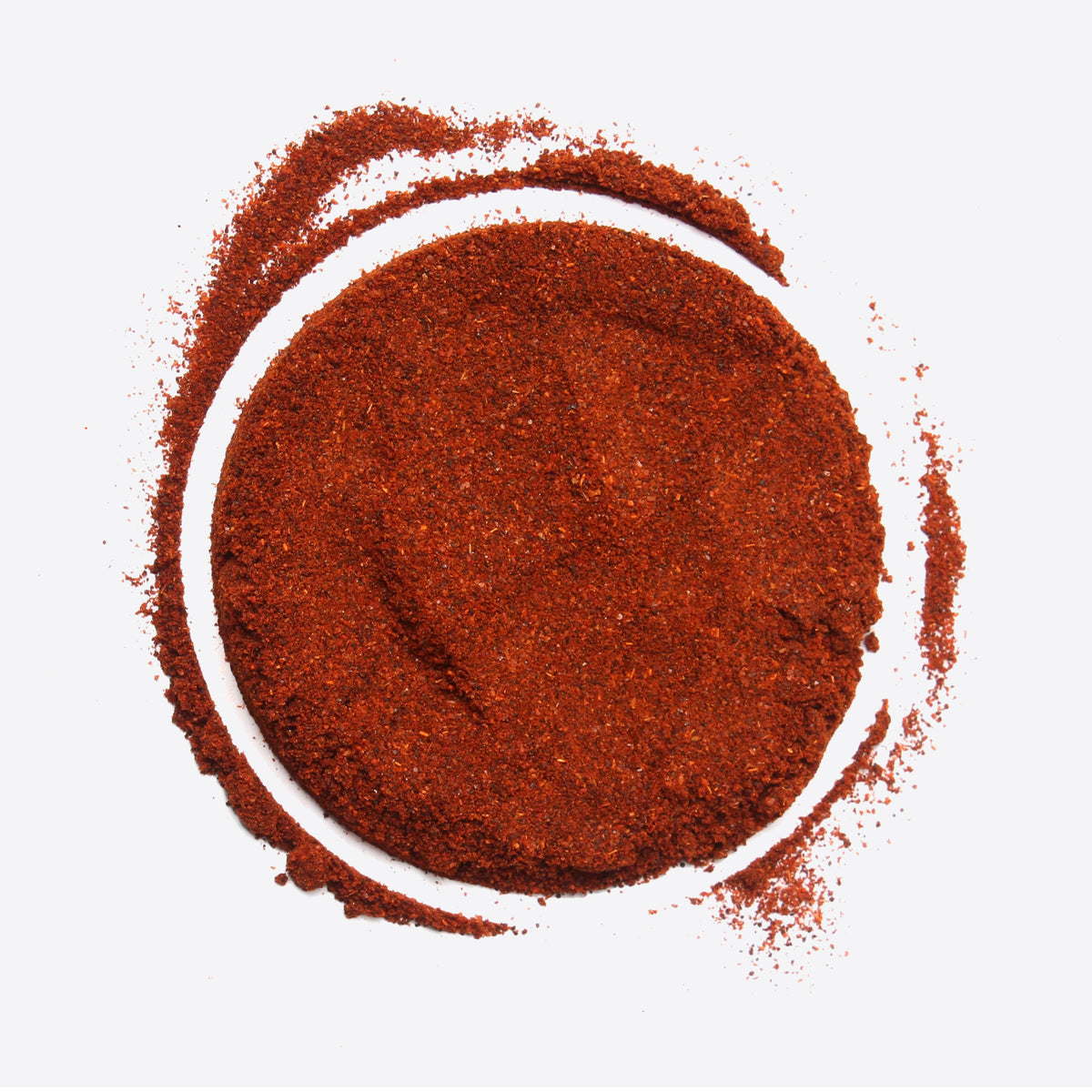 Pile of red chili powder with a curved arc on a white background