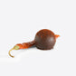 Chocolate truffle coated in red chili flakes with a dried red chili beside it
