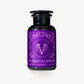 Vosges Haut Chocolat Forest Slumber bath salts in a dark glass jar with an ornately decorated purple label with serif font on a light grey background.