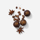 Assorted Midnight Brew truffles with coffee beans and star anise on white background