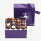 Open box of Vosges Haut-Chocolat Exotic Chocolate Truffles dusted with colorful toppings.