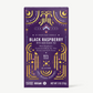 Vosges Black Raspberry Pure Plant chocolate bar stands upright in a dark purple box  decorated with golden suns and moons on a grey background. 