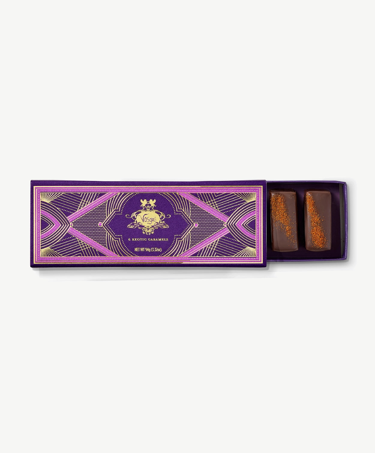 Purple Vosges Chocolate box opened revealing two chocolate covered caramels topped with Kokuto black sugar on a grey background.
