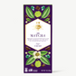 Vosges Matcha Chocolate bar stands upright displaying a purple box  featuring illustrations of tea leaves and flowers on a grey background.